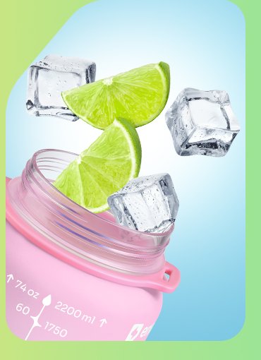 Ice cubes and lime wedges dropping into the wide neck of the half gallon